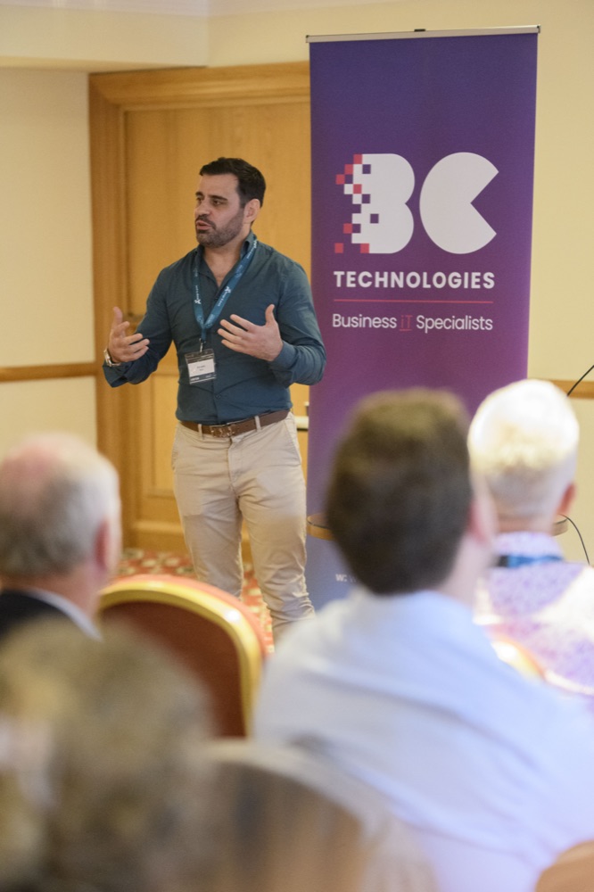 Ed from Strut speaking to a seated audience at a business event