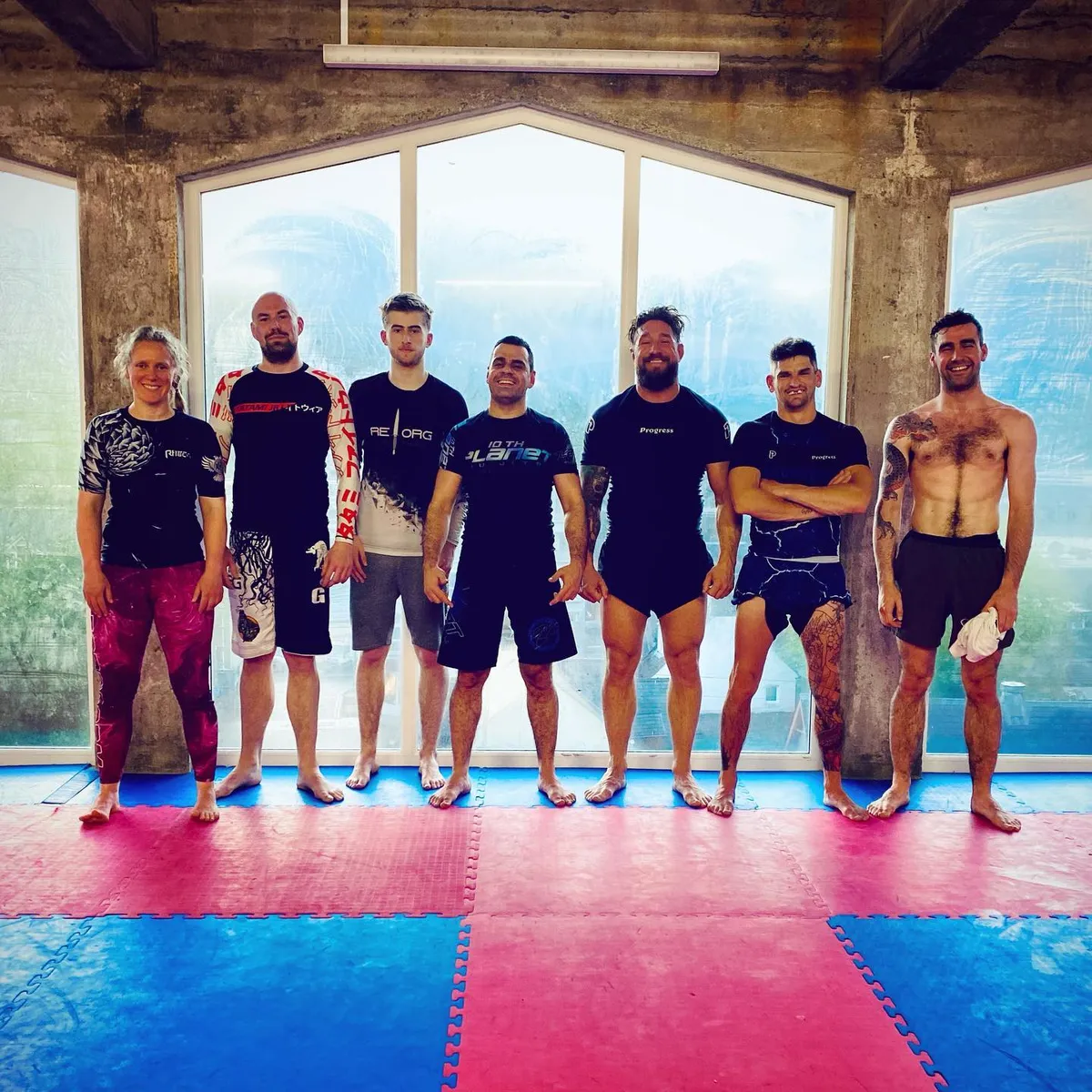 Ed with his Brazilian jiu-jitsu club on the mats.