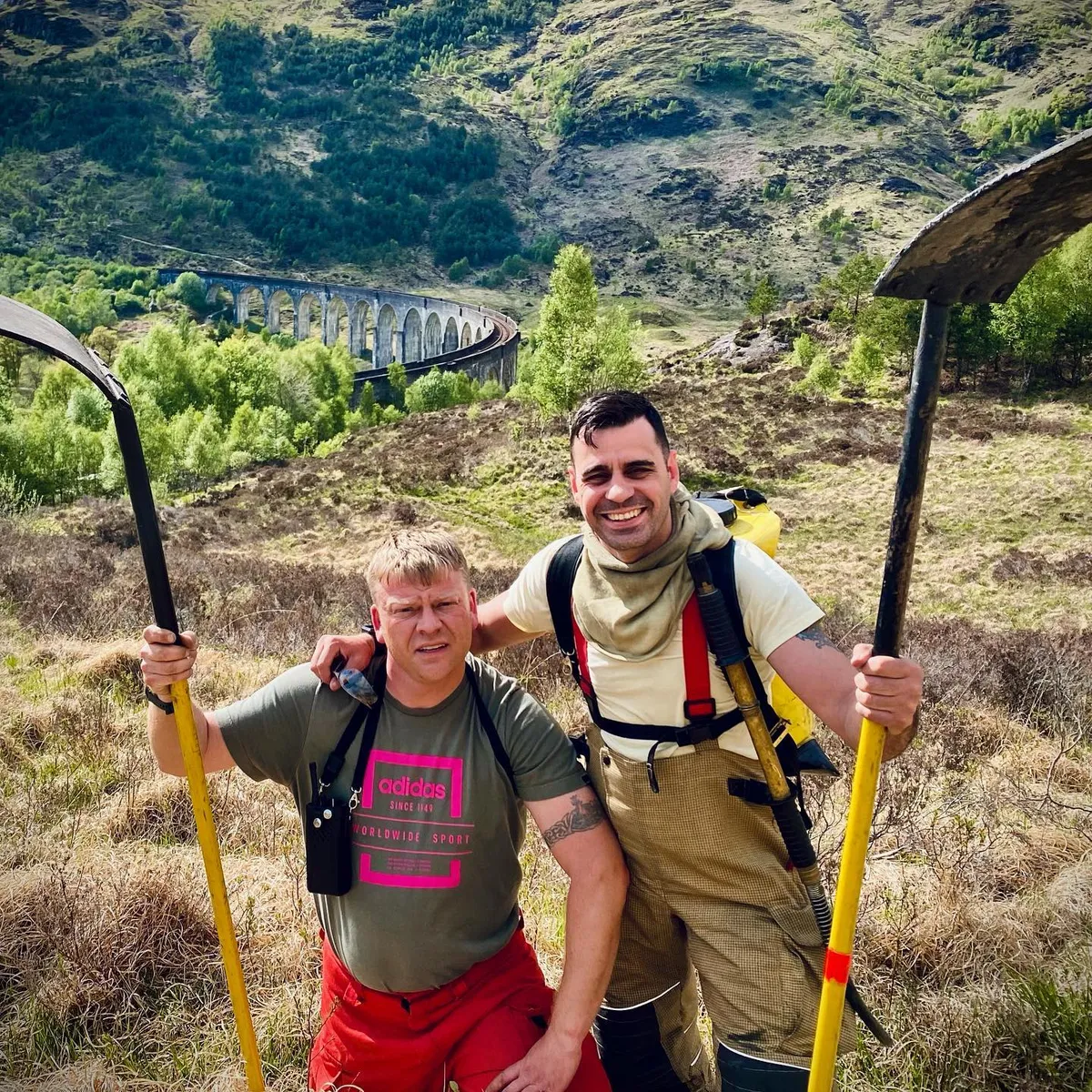 Ed and a fellow firefighter with fire beaters on a Highland hillside: a quick photo between fires.