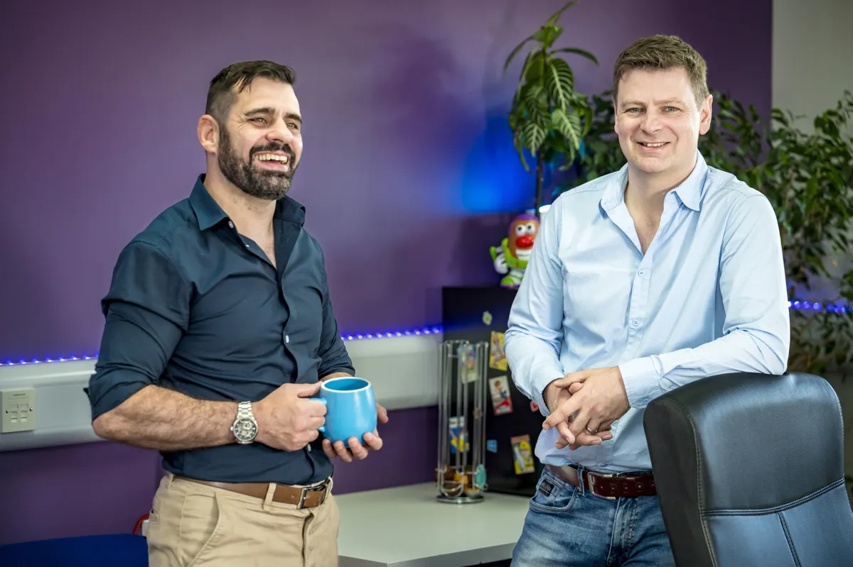 Ed and Chris, Strut’s co-founders, with mugs of coffee in the office.