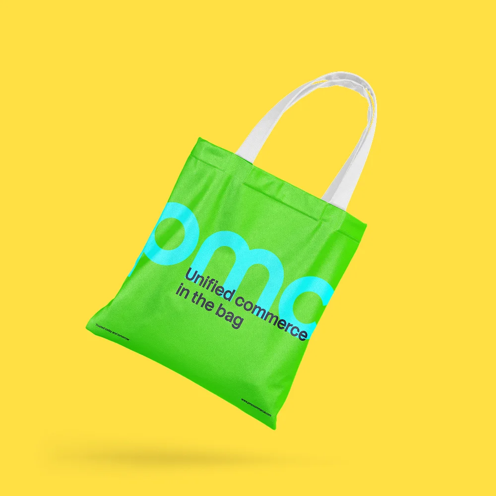 A green tote bag on yellow with the PMC logo and the line “Unified commerce in the bag”.